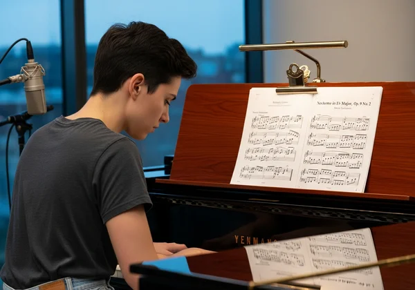 Musician playing piano and sight-reading music